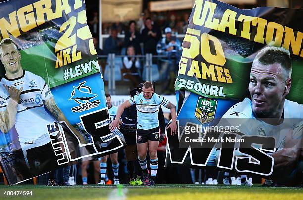 Luke Lewis runs through his banner before the round 18 NRL match between the Cronulla Sharks and the St George Illawarra Dragons at Remondis Stadium...