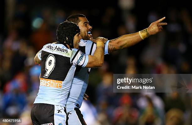 Andrew Fifita and Michael Ennis of the Sharks celebrate a try by Fifita after scoring during the round 18 NRL match between the Cronulla Sharks and...