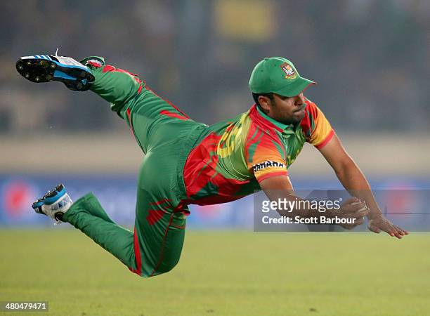 Tamim Iqbal of Bangladesh takes a diving catch to dismiss Dwayne Bravo of the West Indies during the ICC World Twenty20 Bangladesh 2014 match between...
