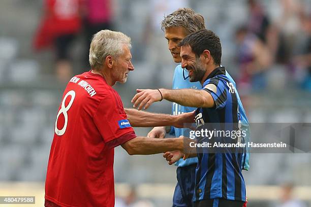 Paul Breitner of Bayern Muenchen Allstars and Hans-Joerg Butt shake hands with Giorgios Karagounis of Mailand after the FC Bayern Allstars against...