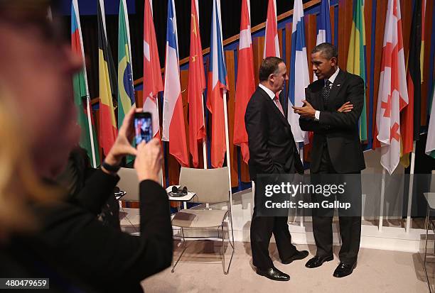 President Barack Obama chats with New Zealand Prime Minister John Key following the closing session of the 2014 Nuclear Security Summit on March 25,...