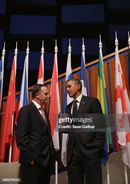 President Barack Obama chats with New Zealand Prime Minister John Key following the closing session of the 2014 Nuclear Security Summit on March 25,...