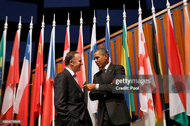 New Zealand's Prime Minister John Phillip Key, left, speaks to U.S. President Barack Obama at the closing session of the 2014 Nuclear Security Summit...