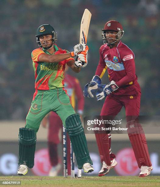 Anamul Haque of Bangladesh bats as Denesh Ramdin of the West Indies looks on during the ICC World Twenty20 Bangladesh 2014 match between Bangladesh...