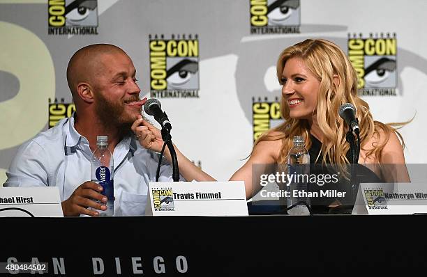 Actress Katheryn Winnick pulls on actor Travis Fimmel's beard as they joke around during a panel for the History series "Vikings" during Comic-Con...