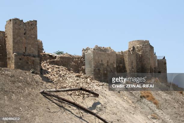 Picture taken on July 12 shows a damaged wall of Aleppo Citadel following a reported explosion the previous night in a tunnel near the monumental...