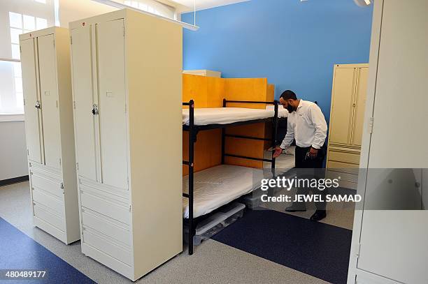 Worker shows a sleeping area during the opening of new homeless shelter of Central Union Mission on 65 Massachusetts Avenue NW in Washington, DC, on...