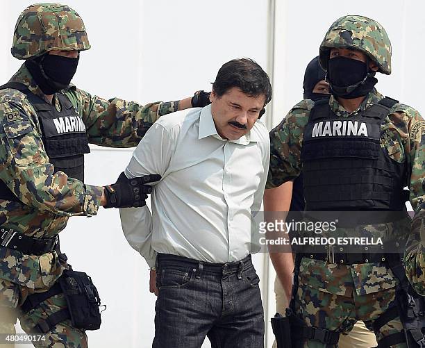 Mexican drug trafficker Joaquin Guzman Loera aka "el Chapo Guzman" , is escorted by marines as he is presented to the press on February 22, 2014 in...