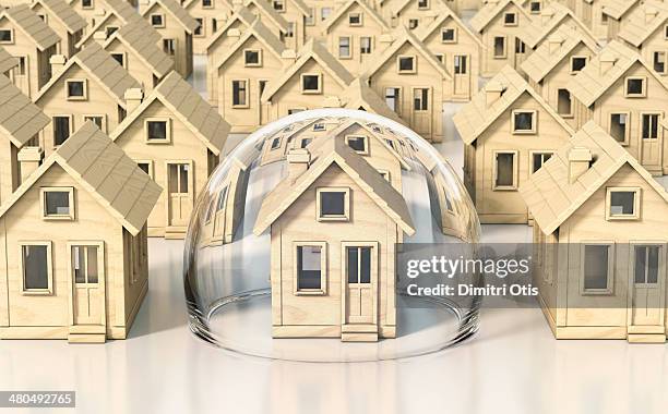 toy wooden miniature houses, one under glass dome - home ownership concept stock pictures, royalty-free photos & images