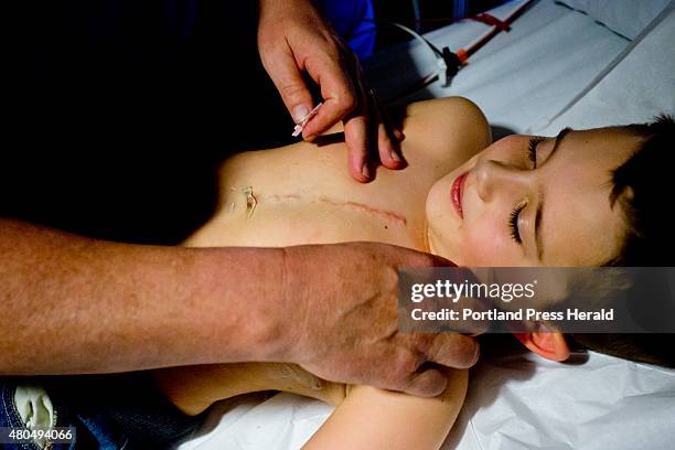 Dennis Atherton, a cardiac stenographer at Maine Medical Center, prepares to check on a mechanical heart valve that was implanted in Mason Lee of...