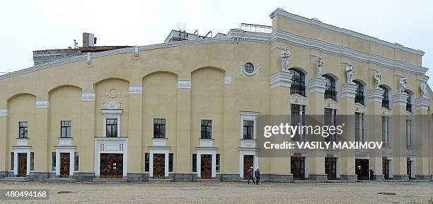 Men walk close to the Central stadium under reconstruction in Yekaterinburg on July 12, 2015. The venue will host matches during the 2018 FIFA World...