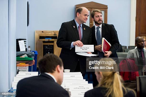 Rep. Tom Reed, R-N.Y., picks up his name card before testifying during the House Budget Committee members' day hearing on FY2015 budget issues on...