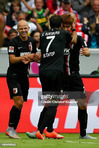 Jeong-Ho Hong of Augsburg celebrates the second goal with Tobias Werner and Halil Altintop of Augsburg during the Telekom Cup 2015 Semi Final match...