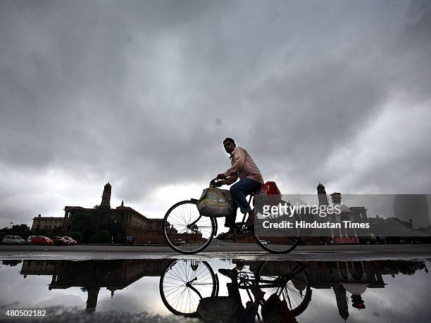 View of dark clouds hover over Rashtrapati Bhavan during pleasant weather in the Capital, at Rajpath, on July 12, 2015 in New Delhi, India. Monsoon...
