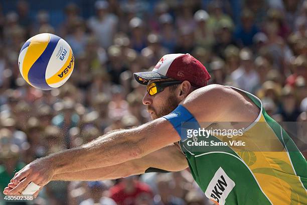 Alison Cerutti of Brasil receives the ball in a final match against Aleksandrs Samoilovs and Janis Smedins of Latvia at the Swatch Beach Volleyball...