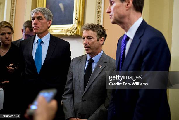 From left, Sens. Mark Udall, D-Colo., Rand Paul, R-Ky., and Ron Wyden, D-Ore., talk with reporters in the Capitol on the NSA's gathering of email and...