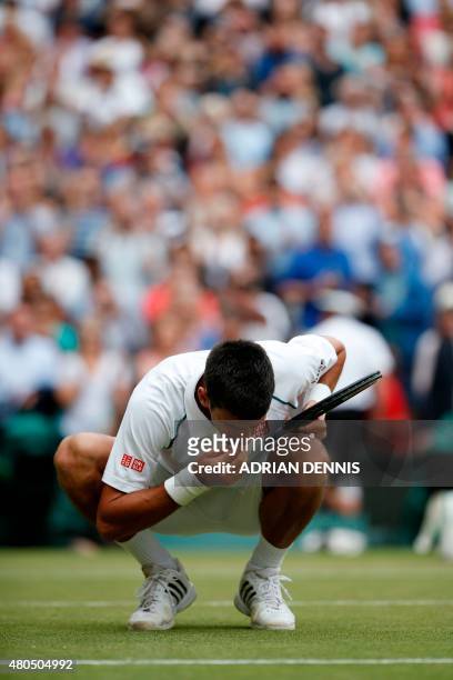 Serbia's Novak Djokovic celebrates beating Switzerland's Roger Federer by eating a blade of grass after their men's singles final match on Centre...