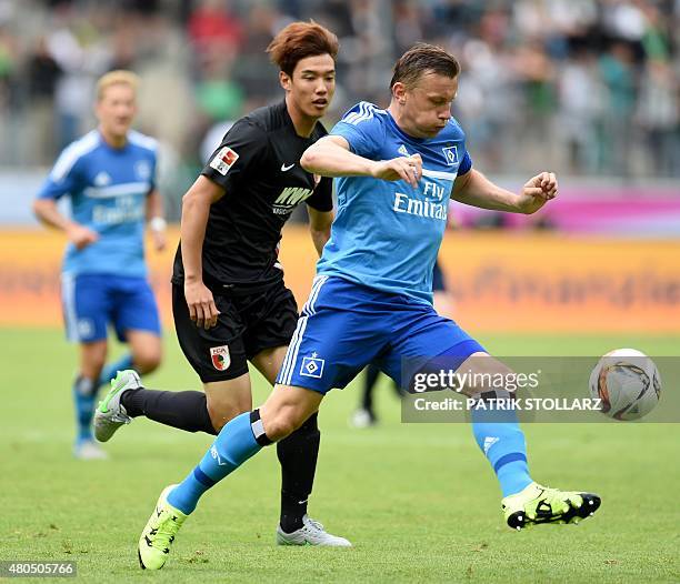 Hamburg's midfielder Ivica Olic and Augsburg's South Korean defender Jeong-Ho Hong vie for the ball during the German Telkom Cup 2015 final football...