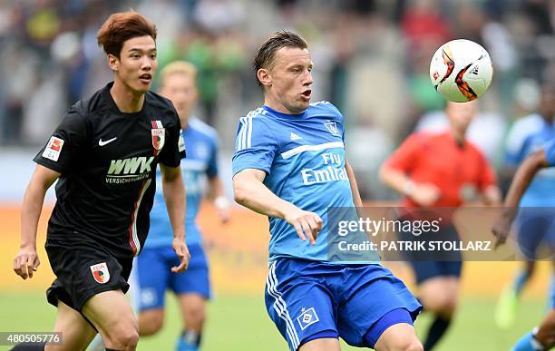 Hamburg's midfielder Ivica Olic and Augsburg's South Korean defender Jeong-Ho Hong vie for the ball during the German Telkom Cup 2015 final football...