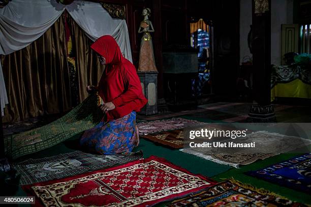 Member of a Pesantren boarding school, Al-Fatah, for transgender people known as 'waria' prepares for pray during Ramadan on July 12, 2015 in...