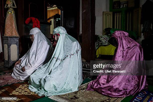 Members of boarding school for transgenders known as pesatren 'waria', called Al-Fatah, pray during Ramadan on July 12, 2015 in Yogyakarta,...