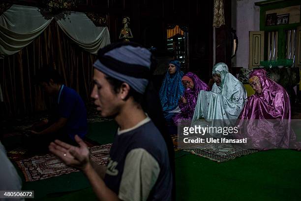 Members of a Pesantren boarding school, Al-Fatah, for transgender people known as 'waria' pray during Ramadan on July 08, 2015 in Yogyakarta,...