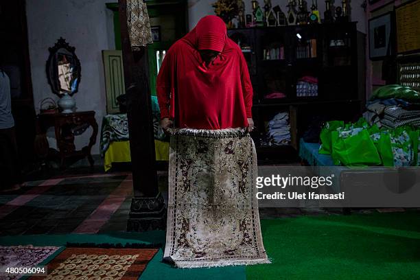 Member of a Pesantren boarding school, Al-Fatah, for transgender people known as 'waria' prepares for pray during Ramadan on July 12, 2015 in...