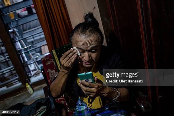 Rulli, a member of a Pesantren boarding school, Al-Fatah, for transgender people known as 'waria' cleans her face during Ramadan on July 12, 2015 in...