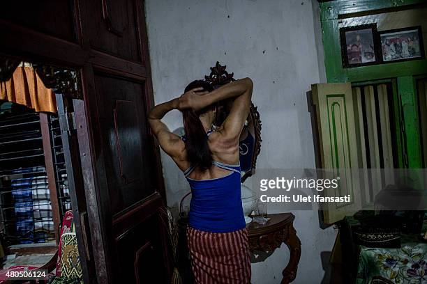 Oky, a member of a Pesantren boarding school, Al-Fatah, for transgender people known as 'waria' looking at the mirror as attend during Ramadan on...