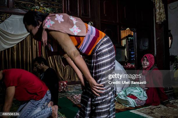 Members of a Pesantren boarding school, Al-Fatah, for transgender people known as 'waria' pray during Ramadan on July 12, 2015 in Yogyakarta,...