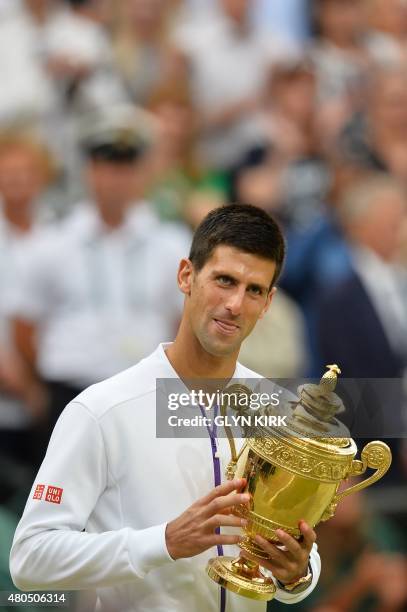 Serbia's Novak Djokovic holds the winner's trophy after beating Switzerland's Roger Federer in the men's singles final match, during the presentation...