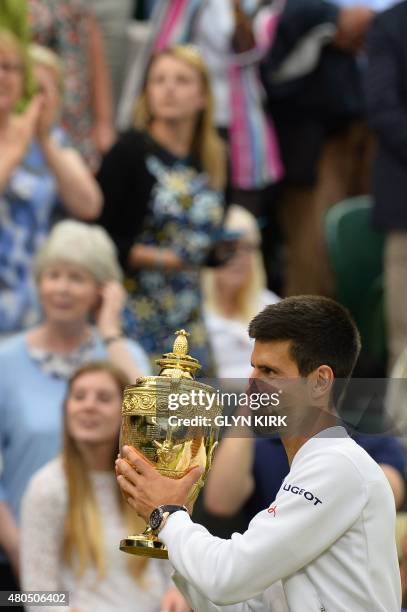 Serbia's Novak Djokovic holds the winner's trophy after beating Switzerland's Roger Federer in the men's singles final match, during the presentation...