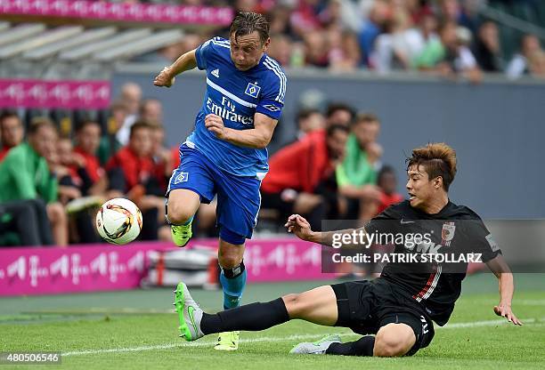Augsburg's South Korean defender Jeong-Ho Hong and Hamburg's midfielder Ivica Olic vie for the ball during the German Telkom Cup 2015 final football...