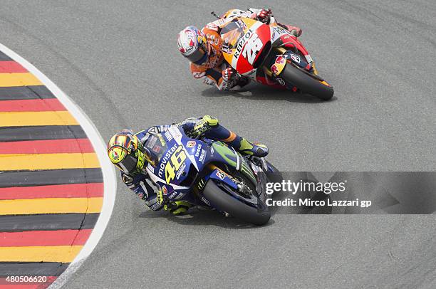 Valentino Rossi of Italy and Movistar Yamaha MotoGP leads Dani Pedrosa of Spain and Repsol Honda Team during the MotoGP race during the MotoGp of...