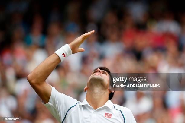 Serbia's Novak Djokovic celebrates beating Switzerland's Roger Federer during their men's singles final match on Centre Court on day thirteen of the...