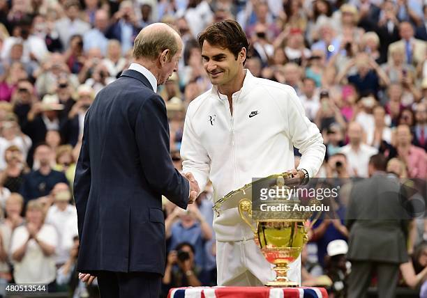 Roger Federer of Switzerland is presented with the runners up trophy by Prince Edward, Duke of Kent after losing to Novak Djokovic of Serbia in the...