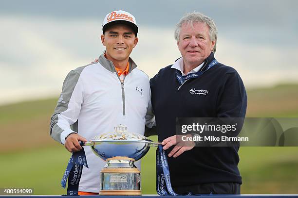 Rickie Fowler of the United States celebrates with the trophy alongside Martin Gilbert, Chief Executive of Aberdeen Asset Management, after winning...