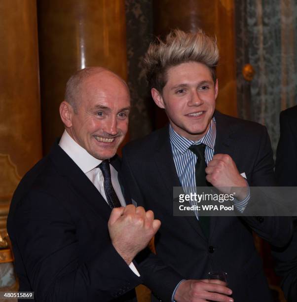 Former professional boxer Barry McGuigan and Niall Horan of One Direction attend the Irish Community Reception at Buckingham Palace on March 2014....