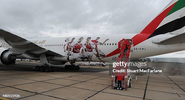 The Arsenal squad board the plane as they travel to Singapore for the Barclays Asia Trophy at Stansted Airport on July 12, 2015 in London, England.