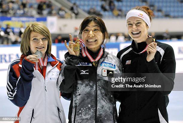 Silver medalist Elise Christie of Great Britain, gold medalist Yui Sakai and bronze medalist Katherine Reutter of the United States pose on the...