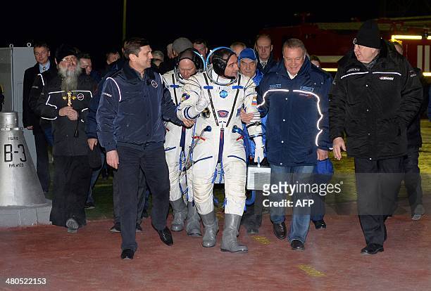 The crew members of a mission to the International Space Station , Russian cosmonauts Alexander Skvortsov and Oleg Artemyev go to board their...