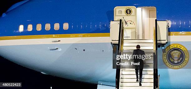 President Barack Obama walks up the stairs of Air Force One before leaving Amsterdam Airport Schiphol March 25, 2014 in Amsterdam, Netherlands. Obama...