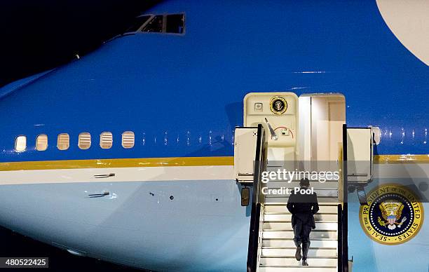 President Barack Obama walks up the stairs of Air Force One before leaving Amsterdam Airport Schiphol March 25, 2014 in Amsterdam, Netherlands. Obama...