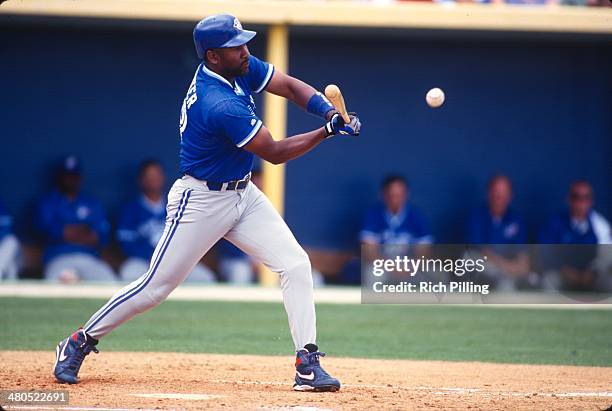 Joe Carter of the Toronto Blue Jays bats during a spring training game at an unspecified location on Thursday, March 20, 1997.