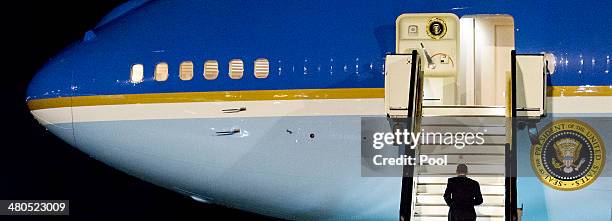 President Barack Obama walks up the stairs of Air Force One before leaving Amsterdam Airport Schiphol March 25, 2014 in Amsterdam, Netherlands. Obama...