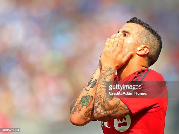 Sebastian Giovinco of Toronto FC reacts after missing a shot against the New York City FC during a soccer game at Yankee Stadium on July 12, 2015 in...