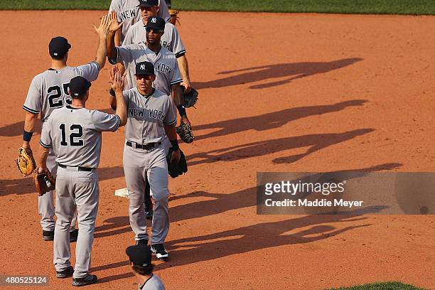Jacoby Ellsbury of the New York Yankees celebrates with Chase Headley after their game against the Boston Red Sox at Fenway Park on July 12, 2015 in...