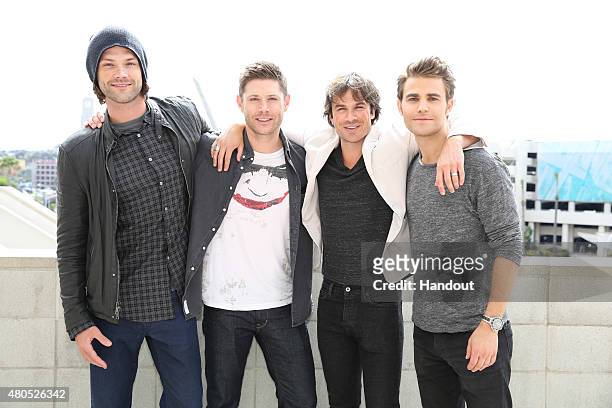 In this handout photo provided by Warner Bros. Entertainment, Inc, SUPERNATURAL stars Jared Padalecki and Jensen Ackles with THE VAMPIRE DIARIES...