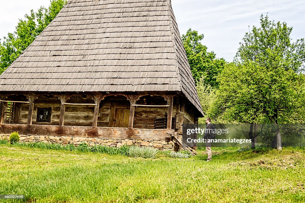 Bearded Man Looking at an Old House