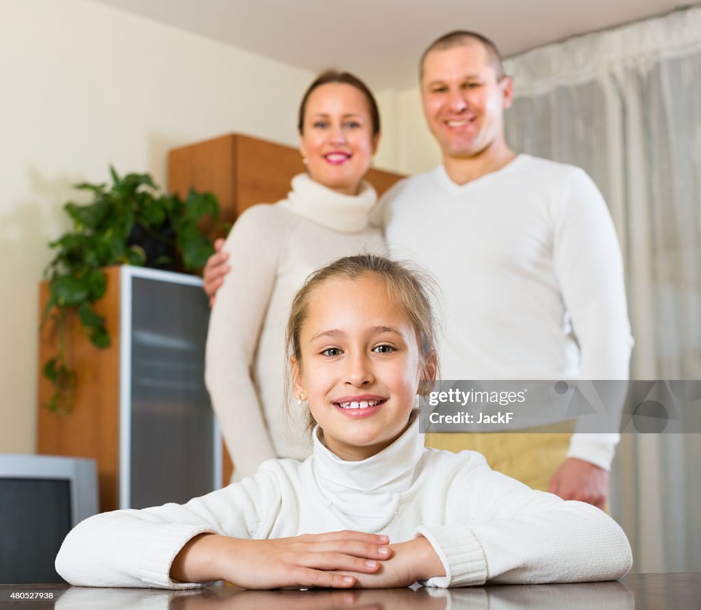 Happy couple with daughter at home